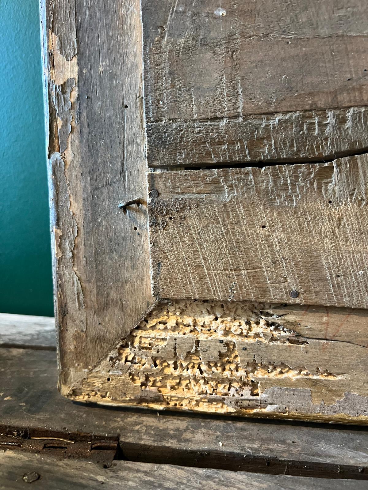 Close-up of the original wooden backboard of an antique La Ferme Anglaise French mirror showing aged wood and wear.