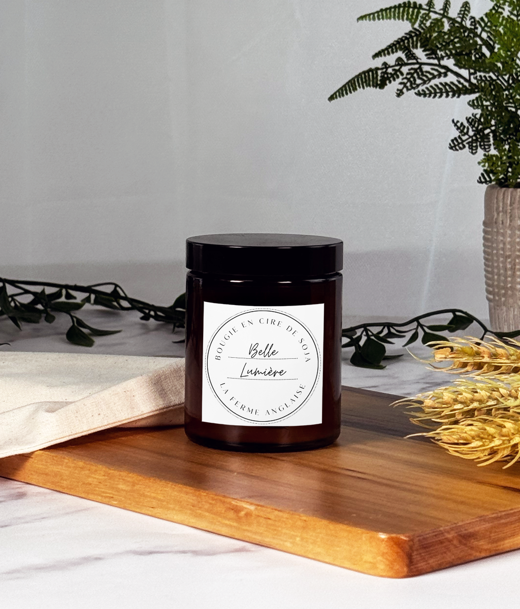 La Ferme Anglaise Belle Lumière hand-poured soy wax candle in an amber glass jar with a black screw-top lid.