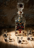 La Ferme Anglaise vintage enamelled glass liqueur decanter set with five glasses featuring folk art floral motifs.