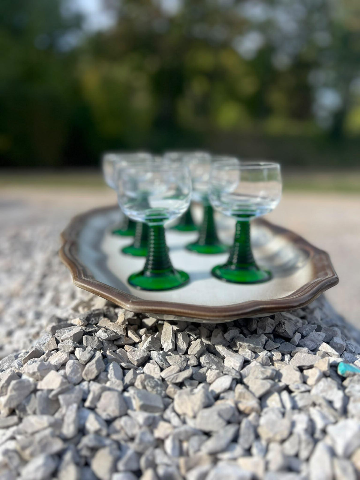 La Ferme Anglaise set of six vintage French bistro wine glasses with clear bowls and vibrant green stems on a tray.