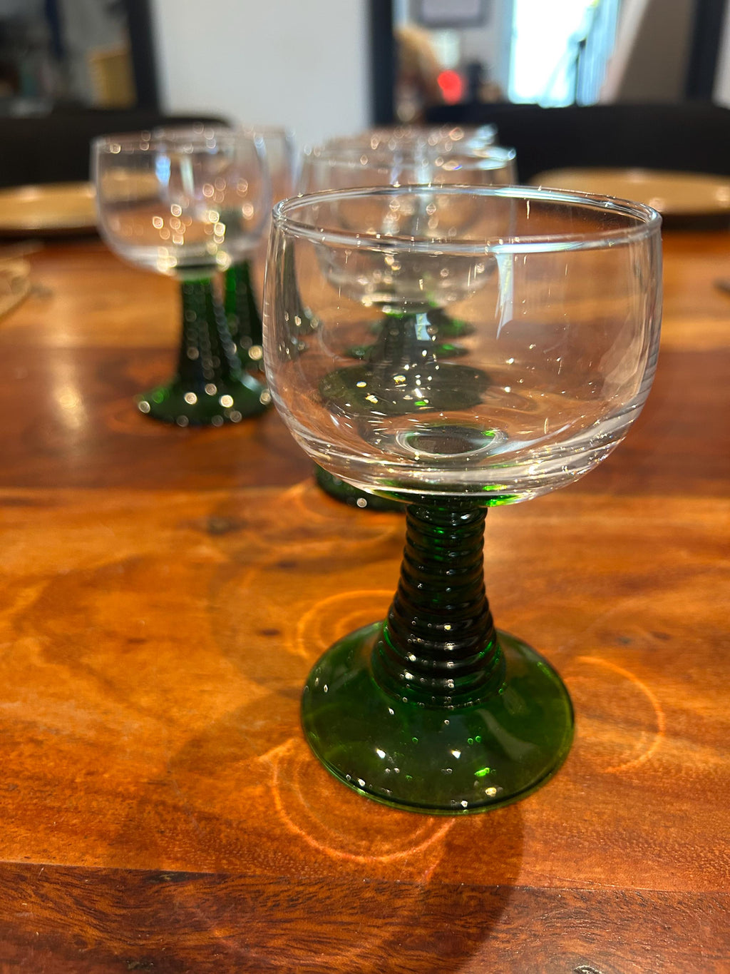 La Ferme Anglaise set of six vintage French bistro wine glasses with clear bowls and ribbed green glass stems.