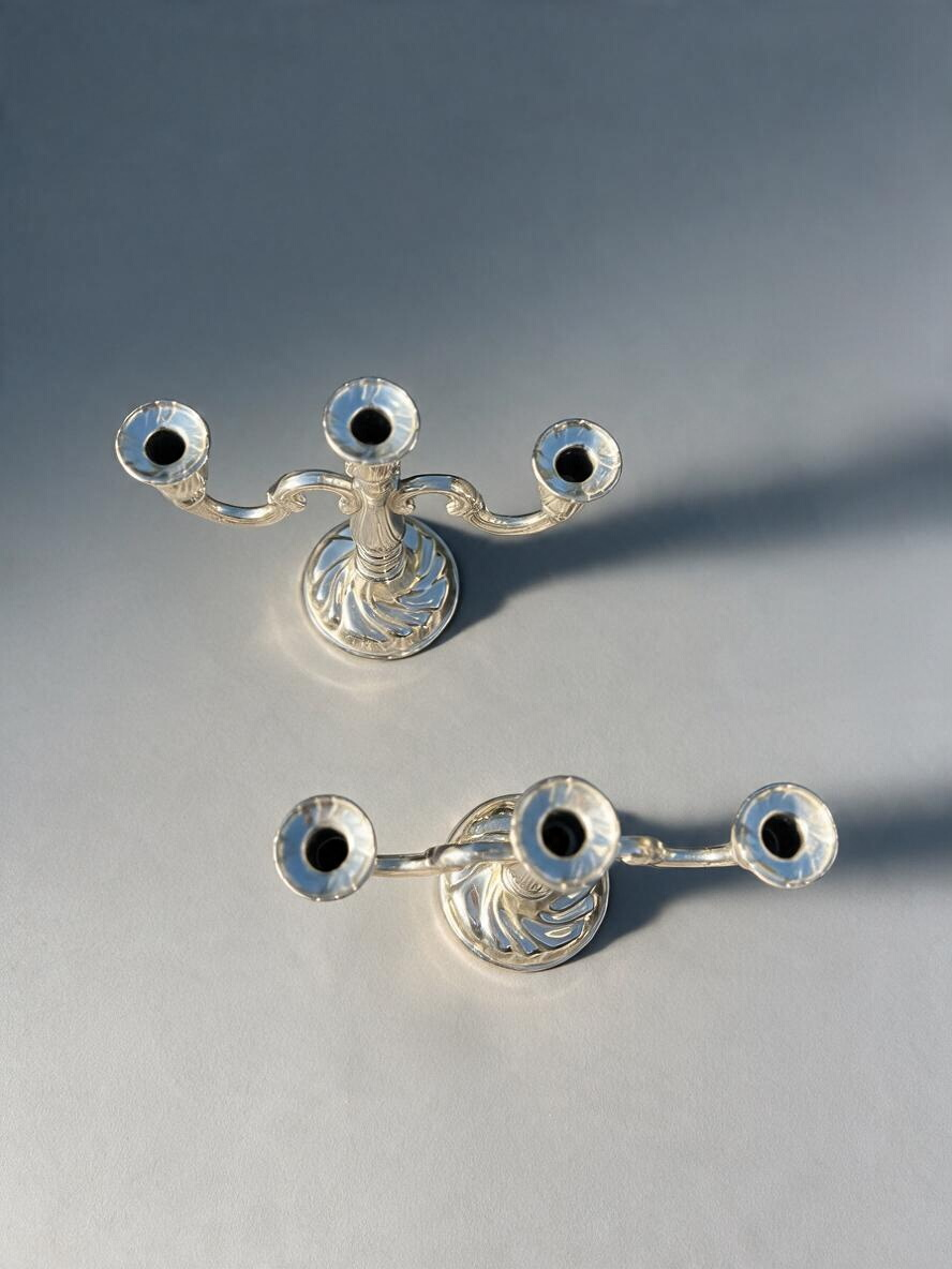 La Ferme Anglaise pair of ornate silver-tone metal 3-arm candelabra with scrolling arms and decorative bases